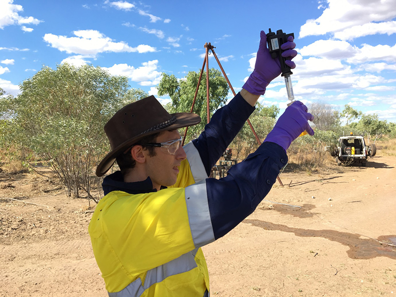 Scientist out in the field taking hydrogeochemistry measurements in the Northern Territory.