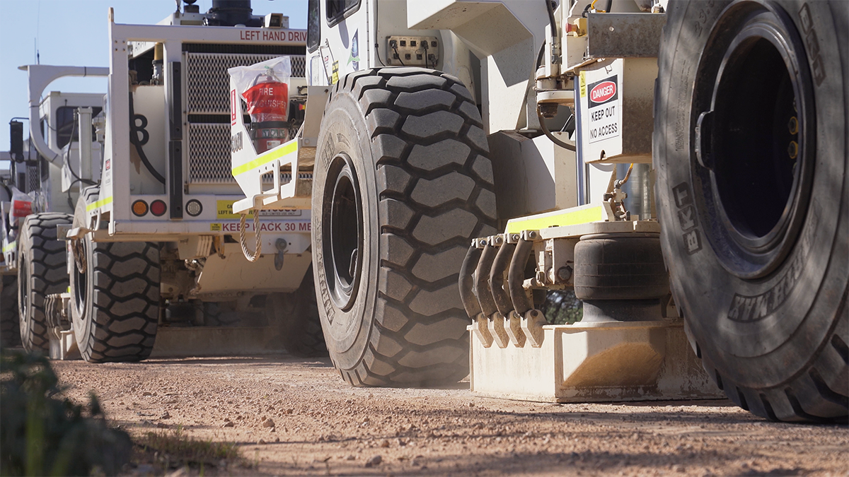 Vibroseis trucks on a dirt road